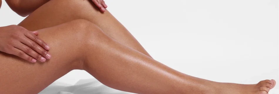 Close-up of a woman’s smooth legs after laser hair removal for dark skin
